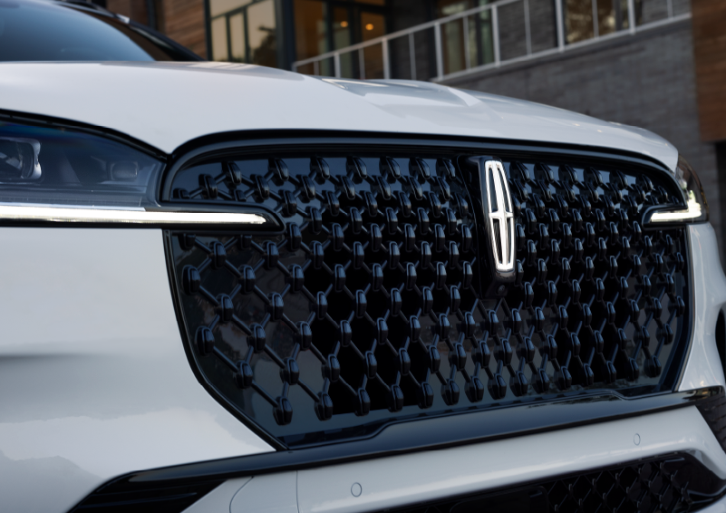 The black grille of a white 2025 Lincoln Aviator® SUV is shown with its fog lights on. | Joe Cooper Lincoln of Edmond in Oklahoma City OK