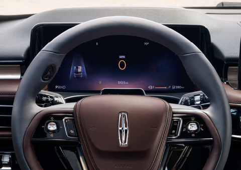 The steering wheel of 2025 Lincoln Aviator® SUV is shown with black and brown accents. | Joe Cooper Lincoln of Edmond in Oklahoma City OK