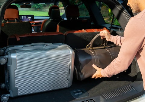 A man loads luggage into the rear of a 2026 Lincoln Aviator® SUV through the opened rear liftgate. | Joe Cooper Lincoln of Edmond in Oklahoma City OK