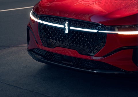 The available front LED light bar and center Lincoln Star logo glow at dusk. | Joe Cooper Lincoln of Edmond in Oklahoma City OK