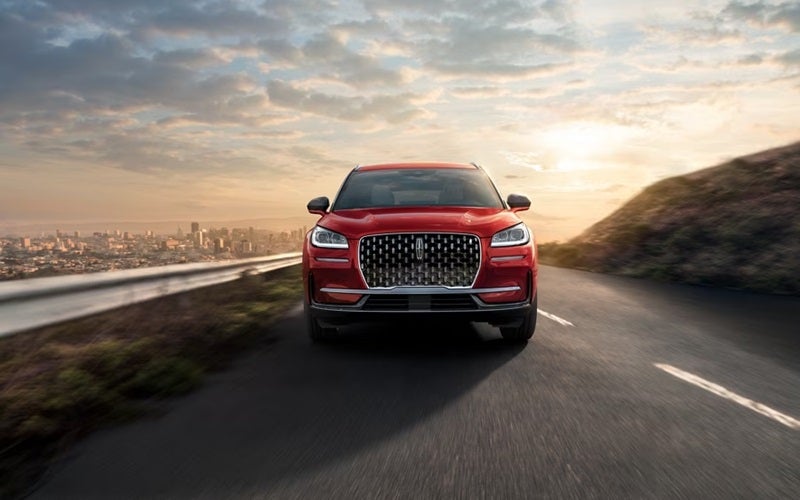 Front view of Lincoln Corsair driving up mountain highway