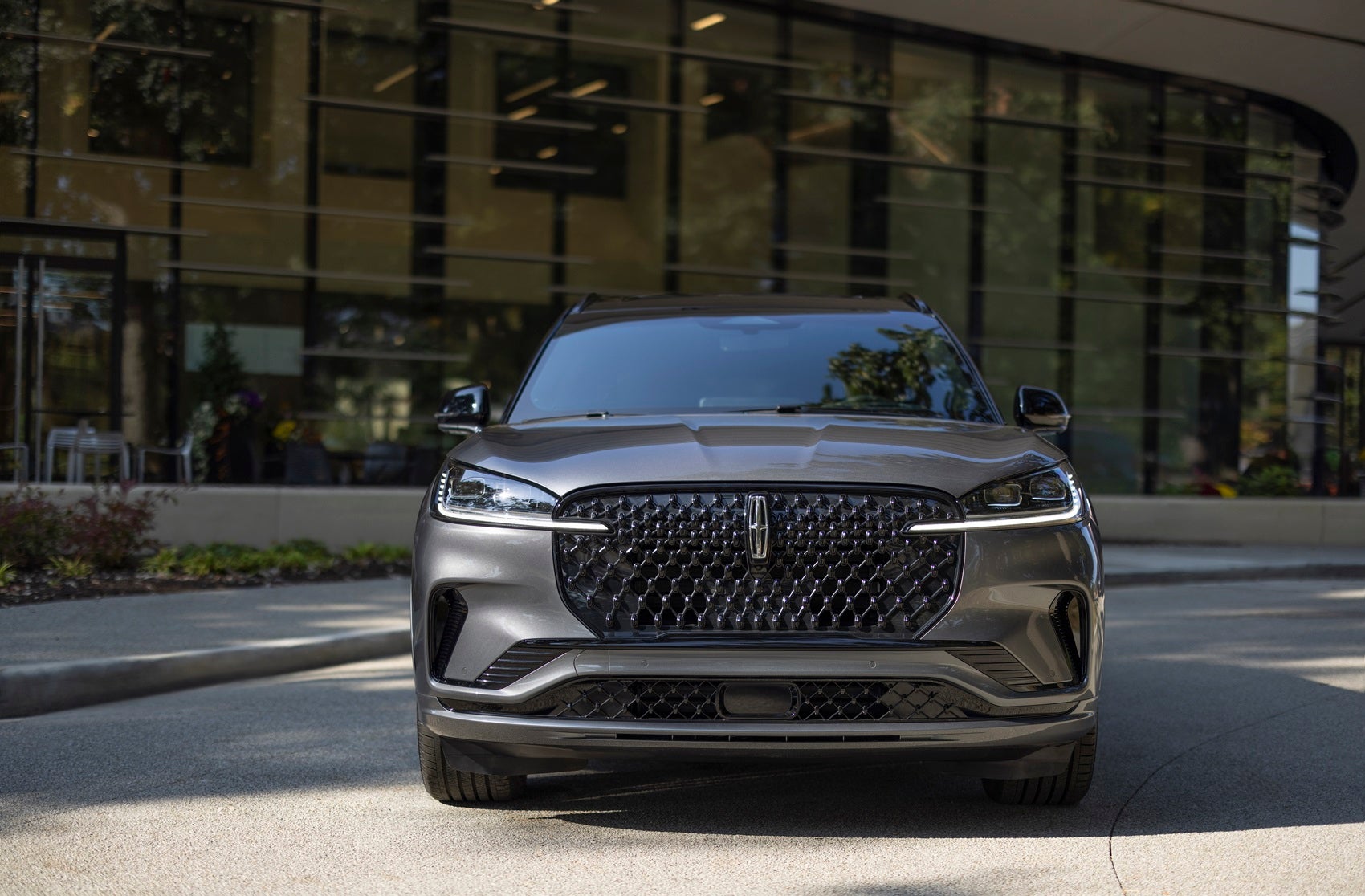 Front view of Lincoln SUV parked in front of building